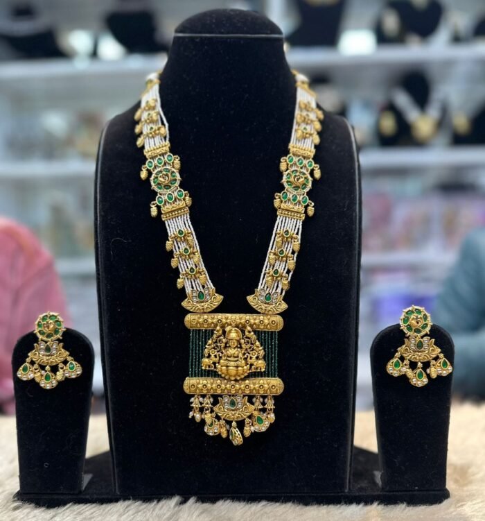 real look temple set with green moti mala and laxmi ji on it